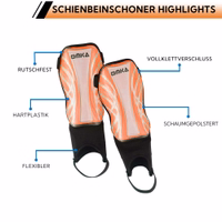 Close-up of orange shin pads highlighting protective EVA foam interior, breathable shell, and adjustable Velcro fastening.