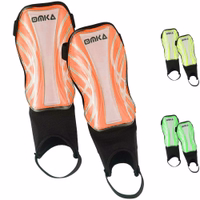 Bright neon orange shin guards front-facing display, high-quality protective soccer gear with ergonomic fit and secure Velcro straps.