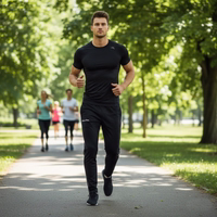 A man standing in STRIKER training pants with an elastic waistband and adjustable drawstring.