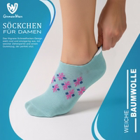 Women’s ankle socks with a snowflake design, lying flat