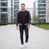 College blouson wool varsity leather jacket A man in a Dark brown college jacket with black leather sleeves and jeans walks down a paved sidewalk in the city