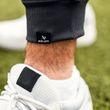 BAUER FLC Core Woven Jogger Senior Black – Cuff Detail Close-up of the ribbed ankle cuff and BAUER logo on the Black FLC Woven Jogger