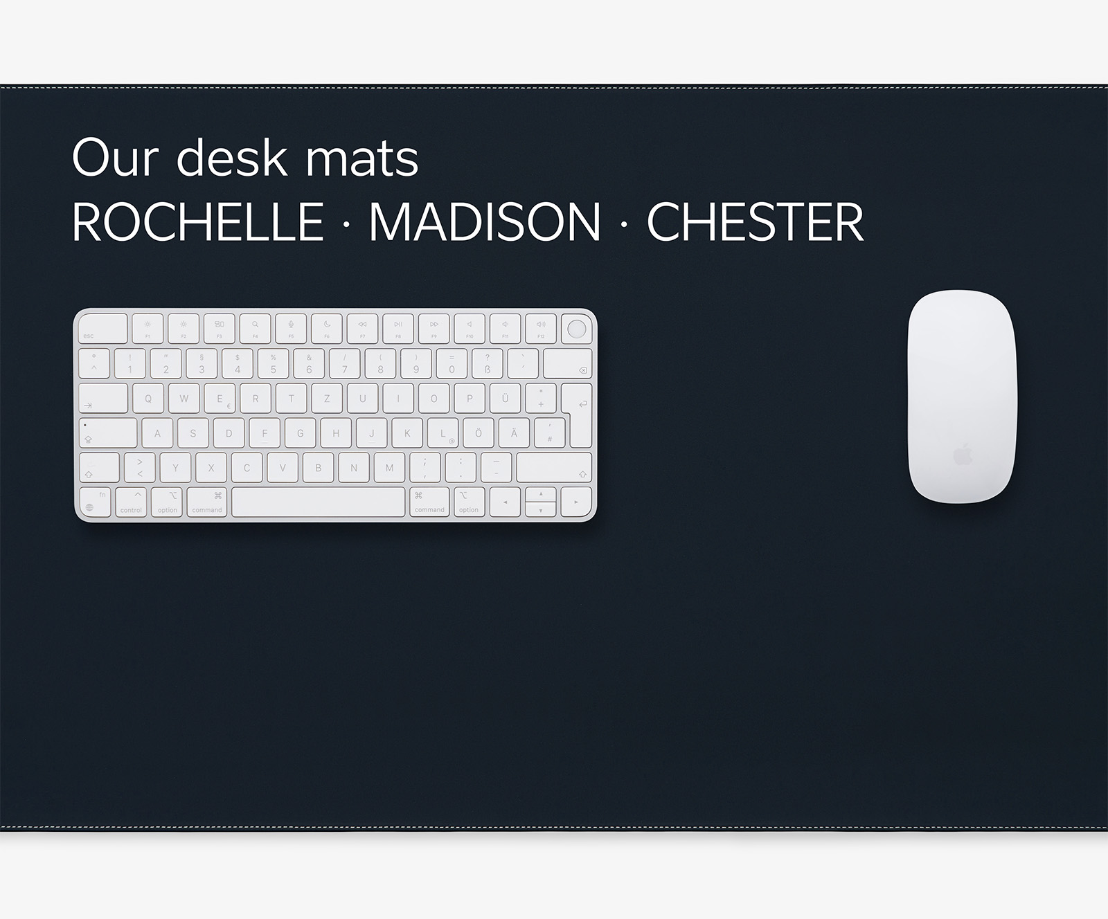 Desk mat made from vegetable-tanned black leather with Apple keyboard and Apple mouse, white contrast stitching around the edges and embossed logo, top view